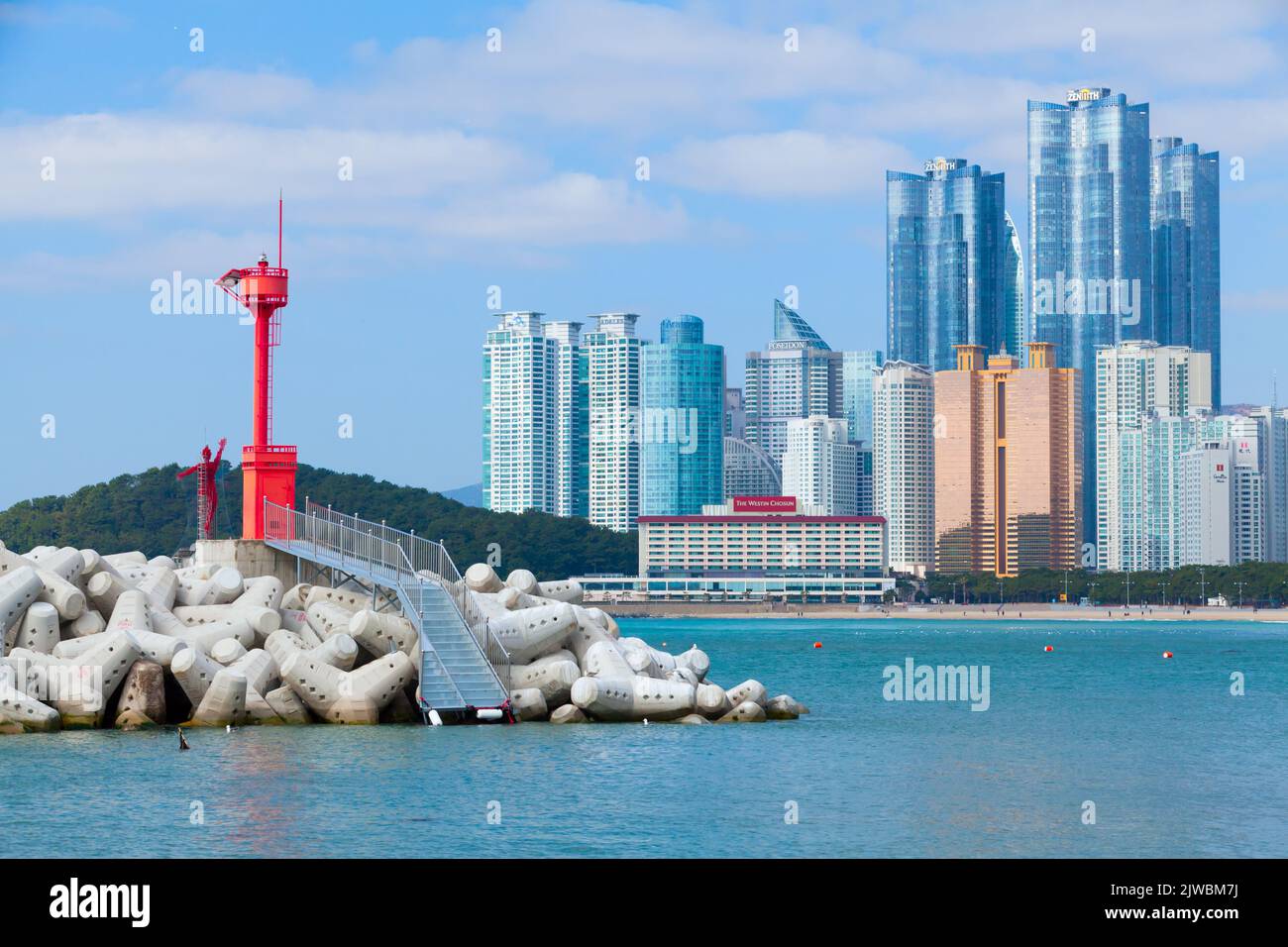 Busan, Südkorea - 17. März 2018: Wellenbrecher mit rotem Leuchtturmturm am Eingang der Haeundae Bucht Stockfoto