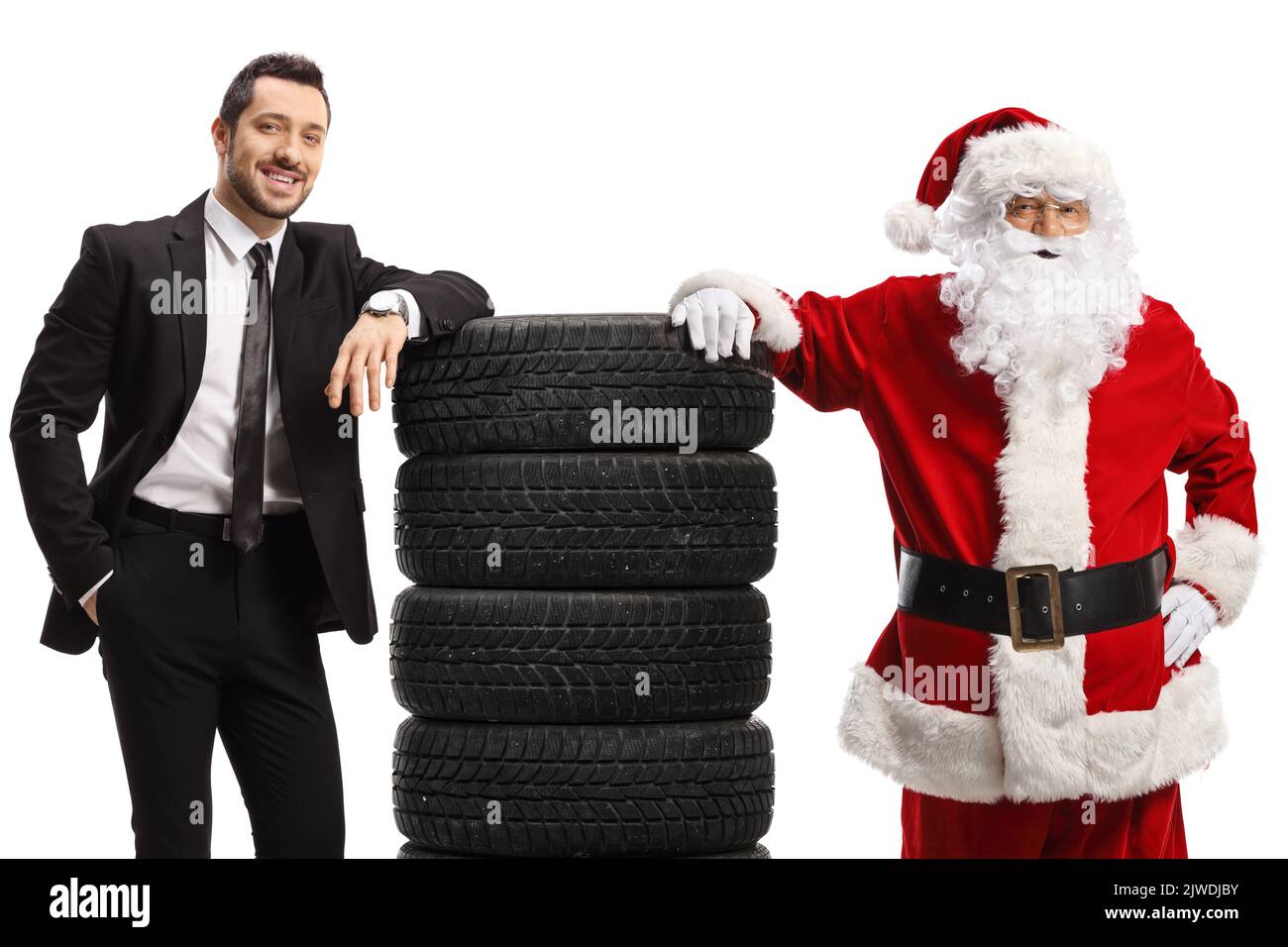 Geschäftsmann und Weihnachtsmann lehnen sich auf einen Haufen Autoreifen isoliert auf weißem Hintergrund Stockfoto