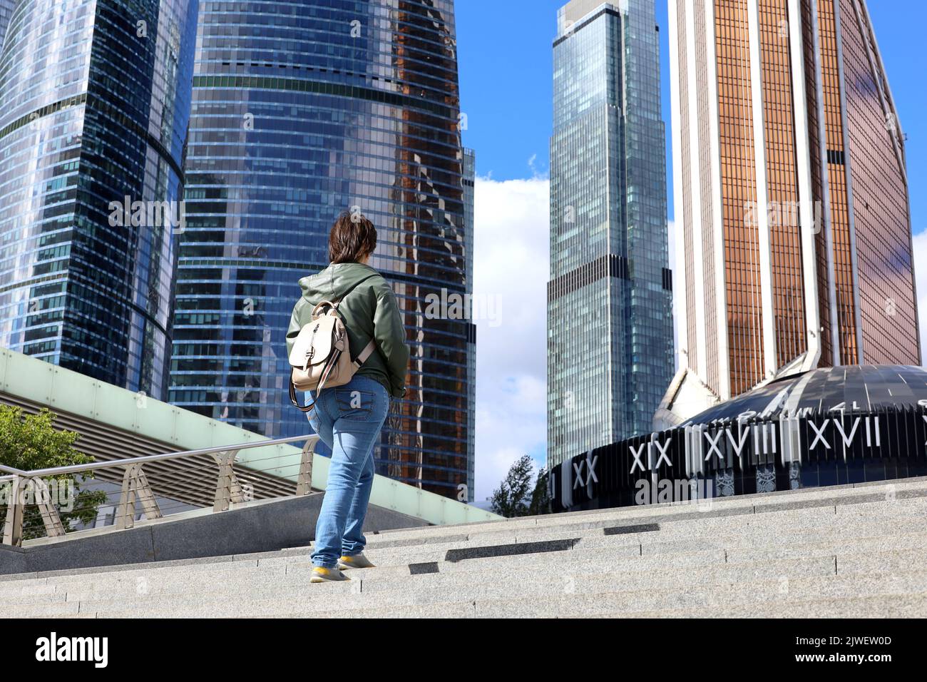 Die Frau geht die Treppe hinauf zu den Wolkenkratzern der Stadt Moskau. Internationales Business Center in der russischen Hauptstadt Stockfoto
