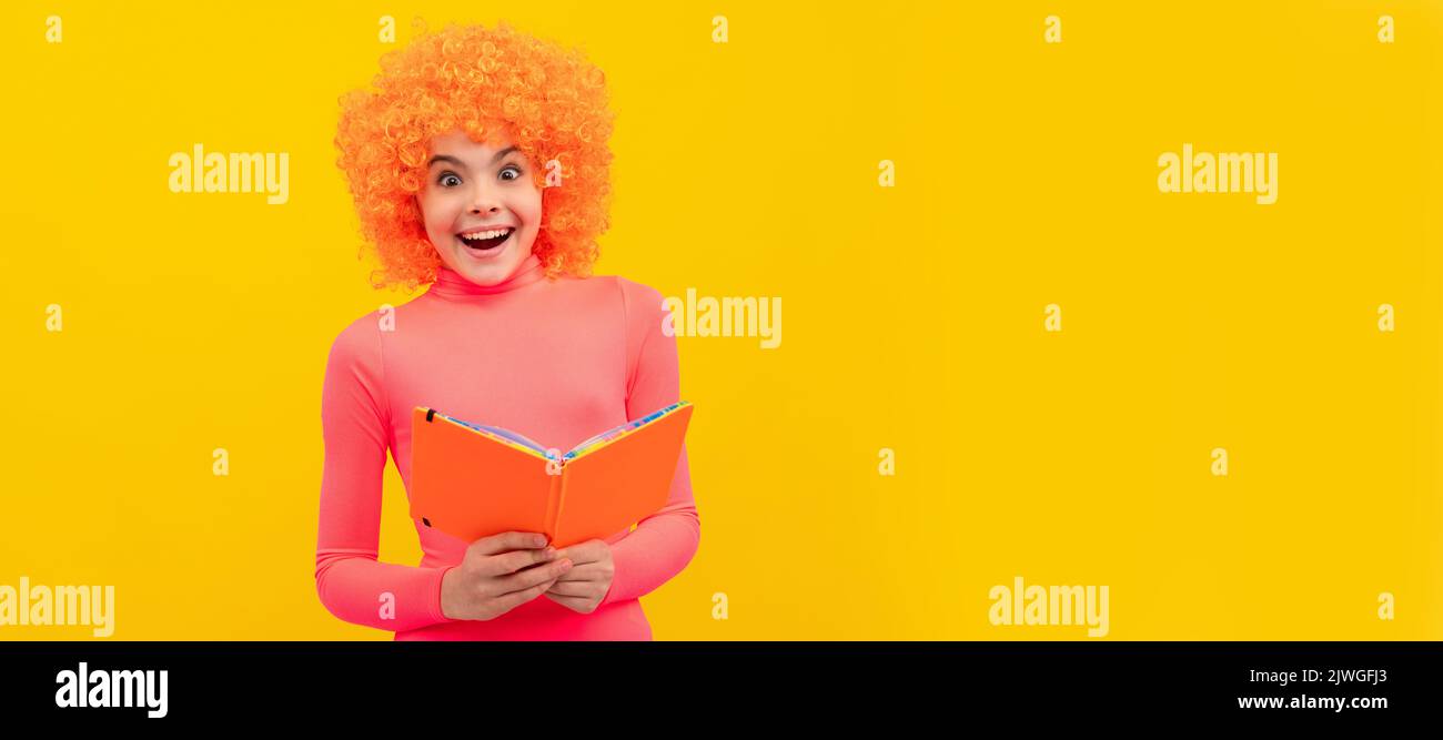 Glückliches Mädchen Kind mit orangen Haaren in rosa Poloneck Lächeln halten Schulbuch, Bildung. Lustige Teenager Kind auf der Party, Poster-Banner-Header mit Kopie Stockfoto