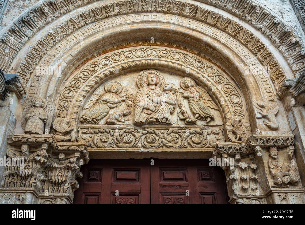 Lunette des Portals von Santa Maria Maggiore mit der madonna und dem Kind auf dem Thron und zwei Engeln und zwei anbetenden. Monte Sant'Angelo, Apulien Stockfoto