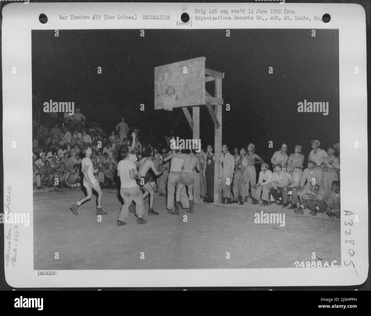 Das Personal des 866. Engineer Aviation Bataillons genießt ein flottes Basketballspiel auf einem Luftstützpunkt irgendwo in Neuguinea. 8. November 1944. Stockfoto
