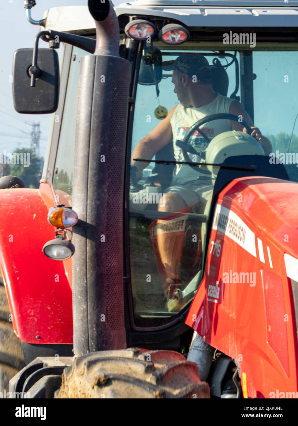 4K Video von rotem Traktor, der das Land auf dem Land pflügt. Stockfoto