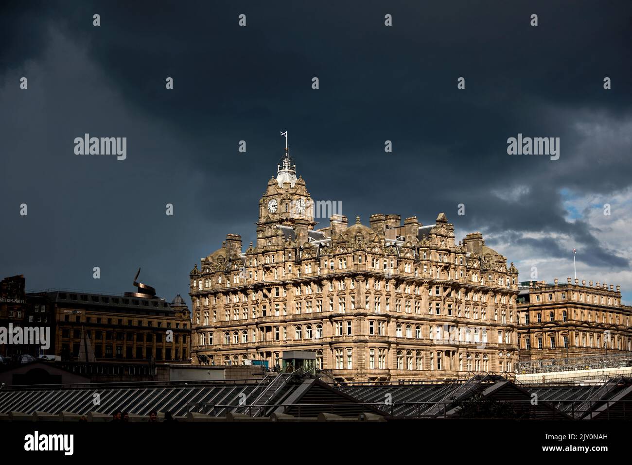 Das Sonnenlicht fällt auf das Balmoral Hotel in der Princes Street, und es kommen immer mehr Regenwolken. Edinburgh, Schottland, Großbritannien. Stockfoto