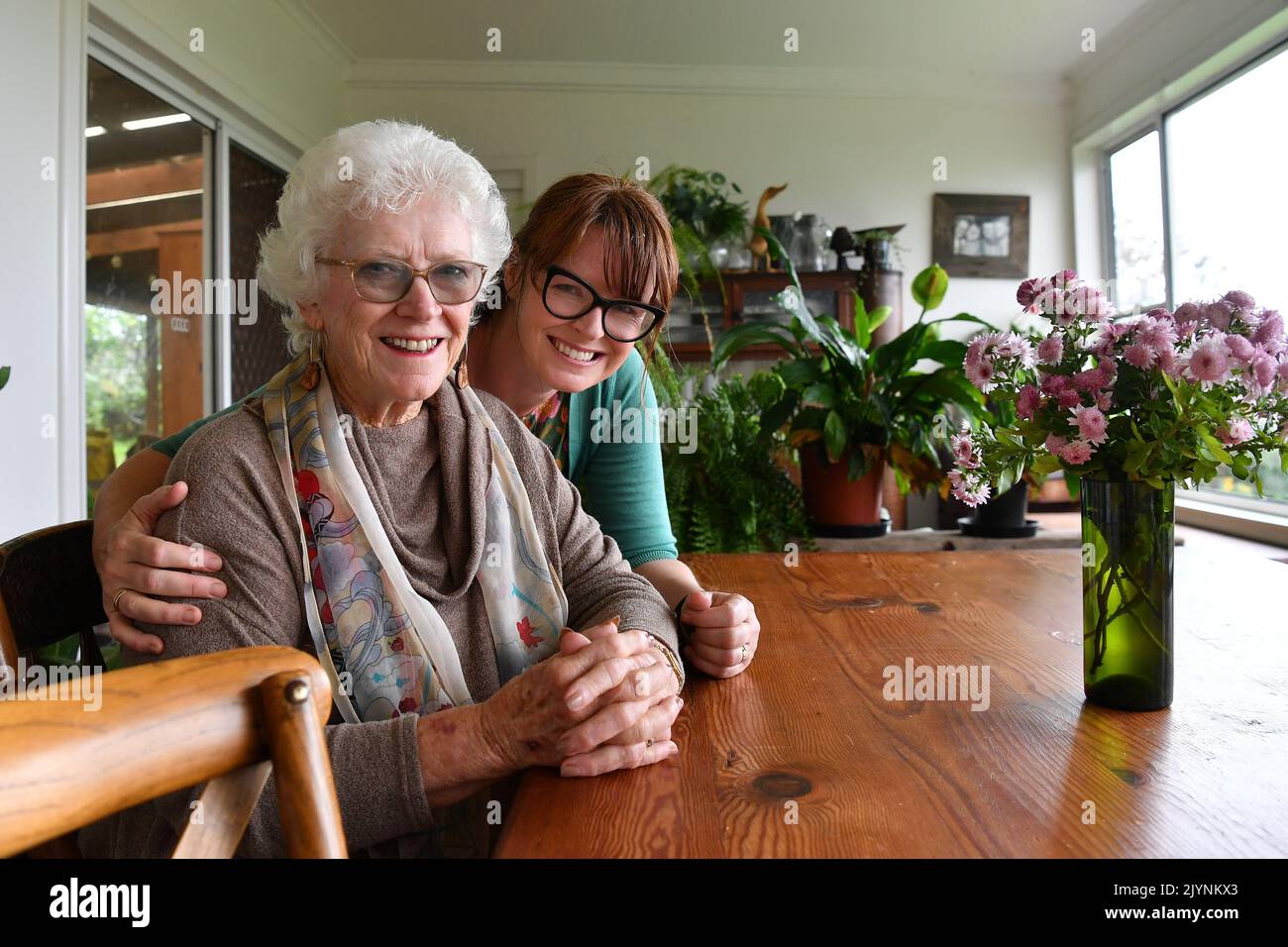 Fiona Walmsley und ihre Mutter Gay betrachten ein Familienporträt von Gay Vierbeiner, darunter Fiona ihre Schwestern Naomi und Suzanne und Bruder Tim von ihrem 21.. Geburtstag, vor dem Muttertag in Gerringong, Freitag, 7. Mai 2021. Gay wird den Muttertag mit ihrer Tochter Fiona verbringen, die sie auf der Familienfarm an der Südküste lebt. (AAP Image/Dean Lewins) KEINE ARCHIVIERUNG ** NUR FÜR REDAKTIONELLE ZWECKE ** Stockfoto