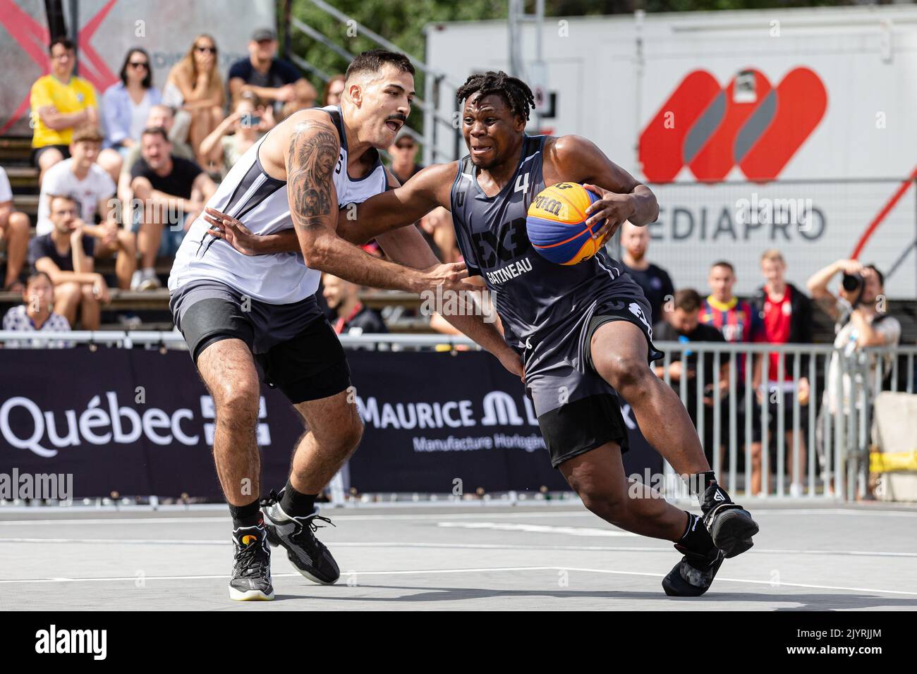 Montreal, Kanada, 03. September 2022: Alain Bernard Louis (grau) vom Team Gatineau aus Kanada im Einsatz gegen André Ferros während der Qualifikationsrunde der FIBA 3x3 World Tour Montreal Masters 2022 vom Team São Paulo DC aus Brasilien auf dem Place des Festivals in Montreal, Kanada. Team Gatineau aus Kanada gewann das Spiel mit der Punktzahl 21-20. Stockfoto