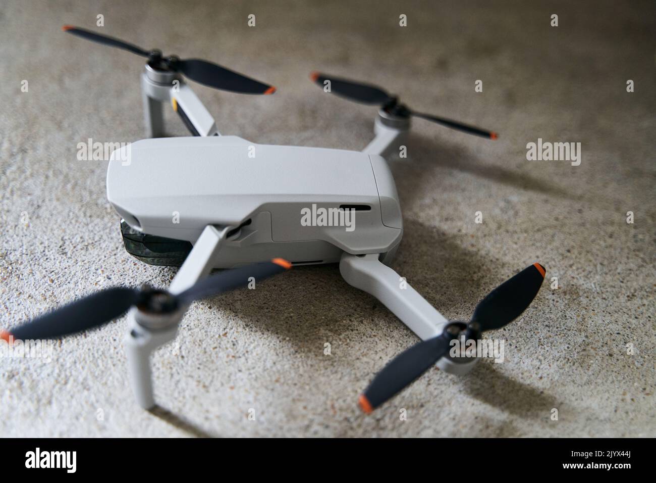 Kleiner grauer Quadcopter auf grauem Hintergrund. Nahaufnahme des Quadrocopters. Stockfoto