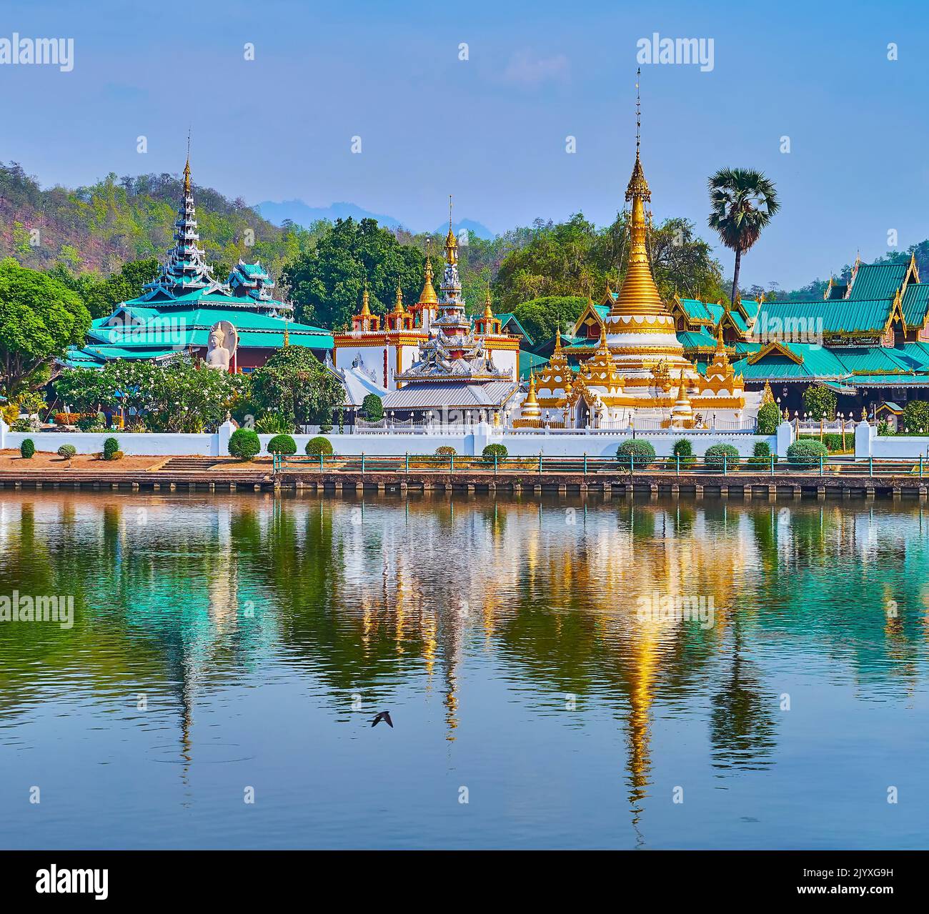 Die historischen Tempel Wat Chong Kham und Wat Chong Klang sowie ihre Stupas und Pyathen spiegeln sich auf den Gewässern des Nong Kham Lake, Mae Hong Son, Thaila Stockfoto