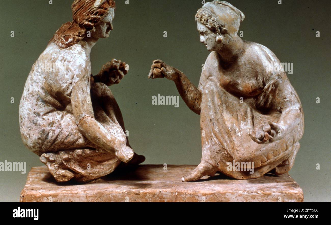 Griechisch beeinflusste, bemalte Terrakotta-Statue von zwei Frauen, die Knöchelknochen spielen. Campanian, 330BC-300BC, Italien, Kampanien. Stockfoto