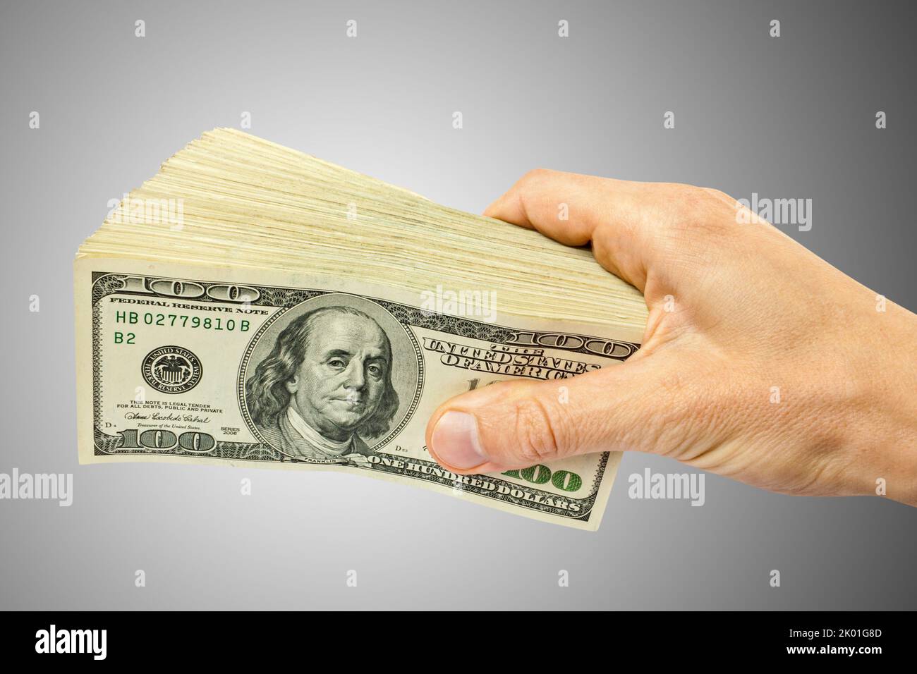 große Haufen Geld (US-Dollar) in der hand Stockfoto