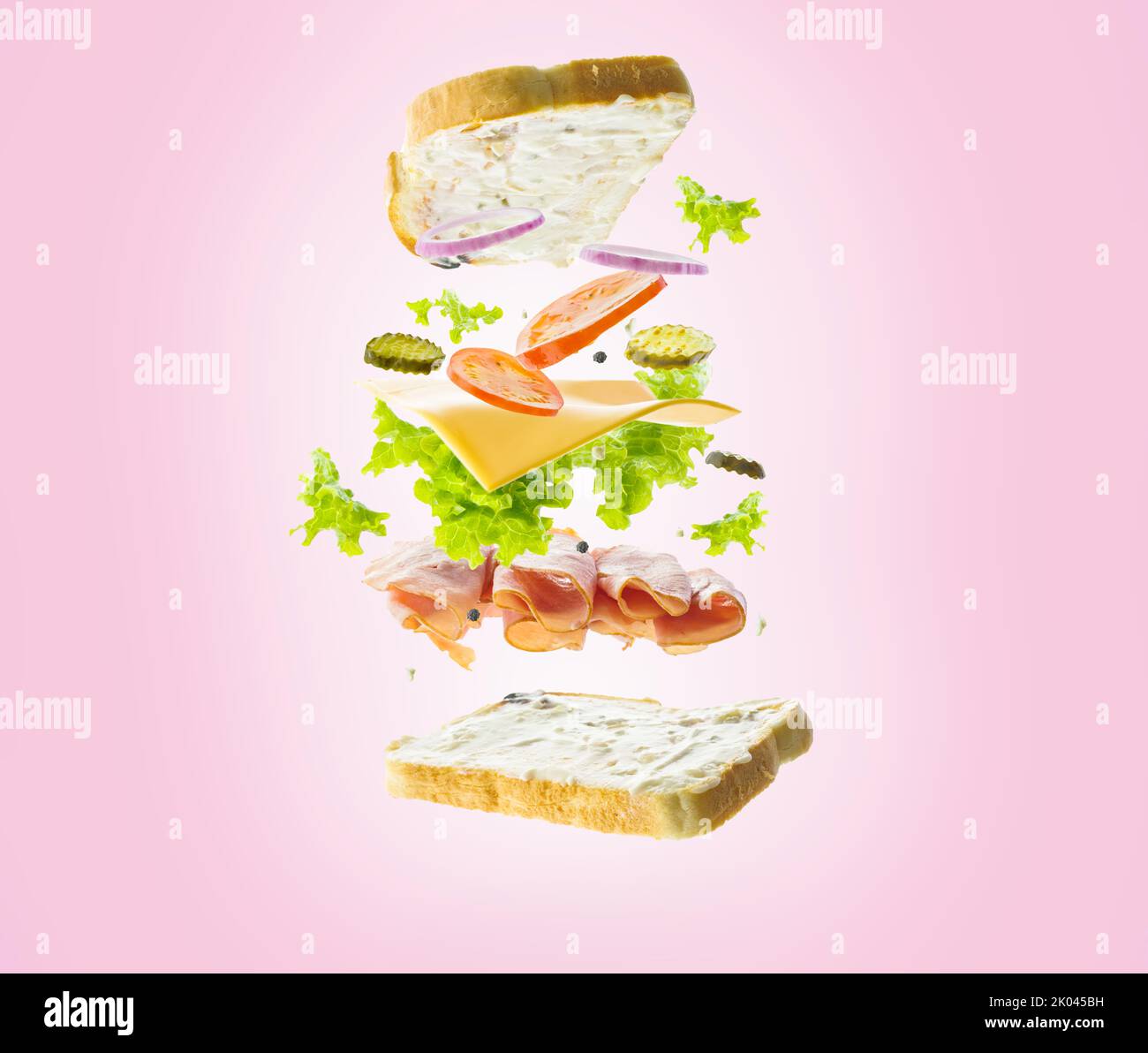Klassisches amerikanisches Sandwich im gefrorenen Flug auf einem rosa Hintergrund. Fast Food, Vitamine, Eiweiß, Bio-Produkte. Restaurant, Hotel, Café, Catering, ho Stockfoto