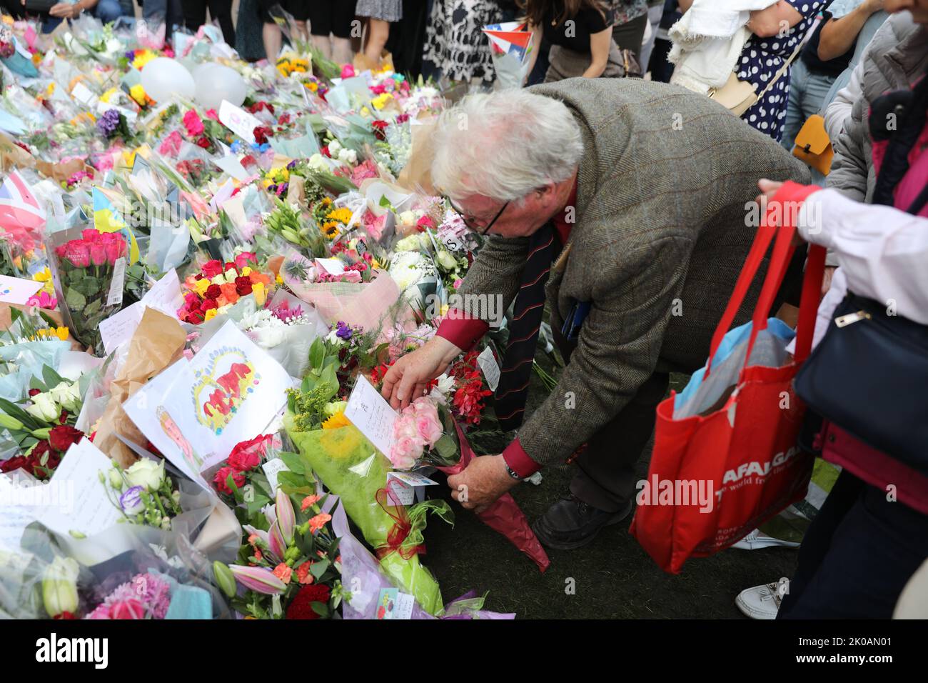London, Großbritannien. 10. September 2022. Ein älterer Mann stellt Blumen in ein Meer von Blumengebeten an Ihre Majestät die Königin. Kredit: Simon Ward/Alamy Live Nachrichten Stockfoto