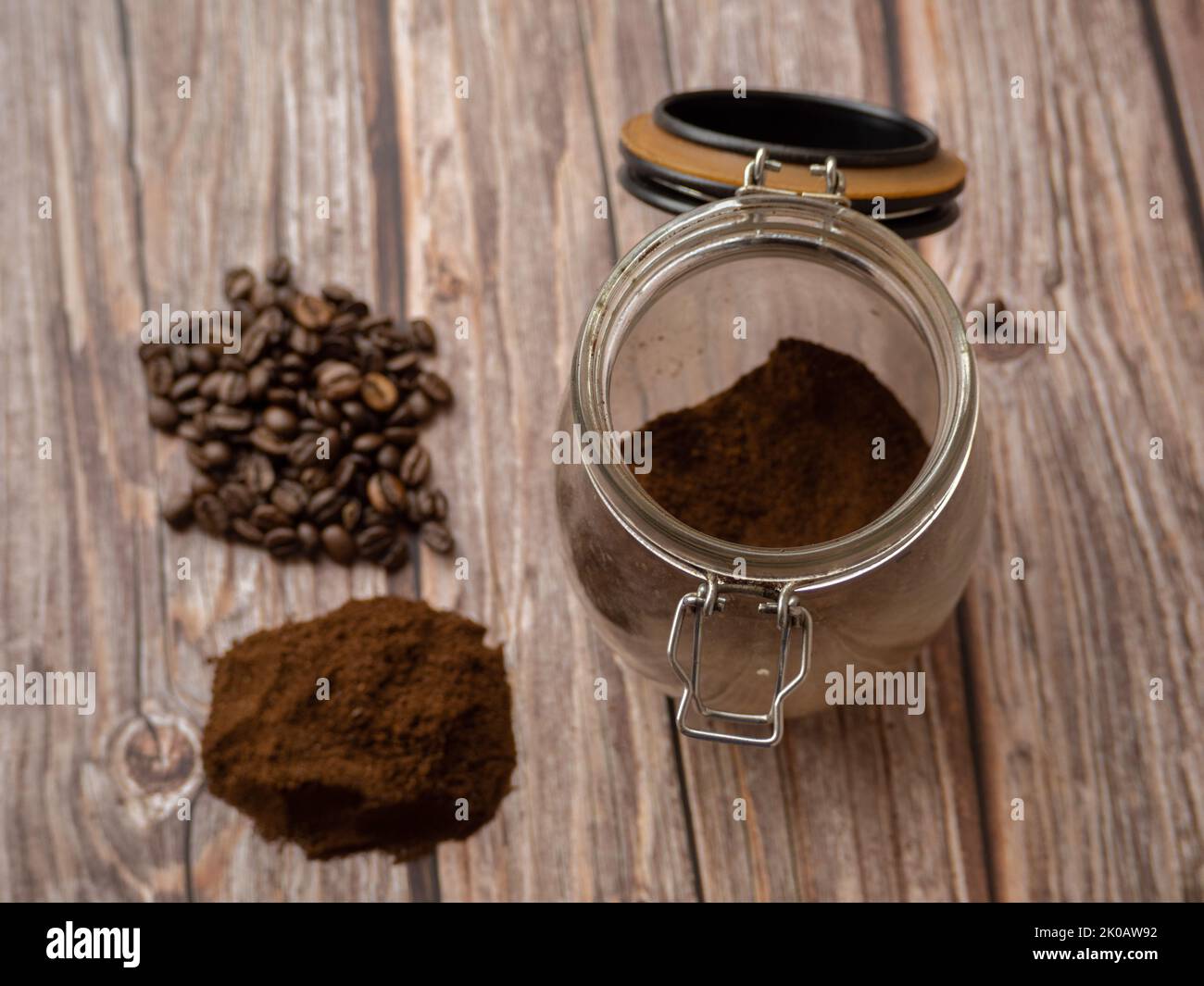 Stapel von gemahlenem Kaffee und Kaffeebohnen isoliert auf weißem Hintergrund Nahaufnahme. Glas mit gemahlenem Kaffee. Stockfoto