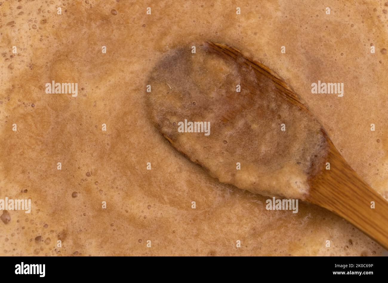 Ein Holzlöffel in Apfelmarmelade - in den Prozess des Kochens Apfelmarmelade - Rezept Konzept Stockfoto