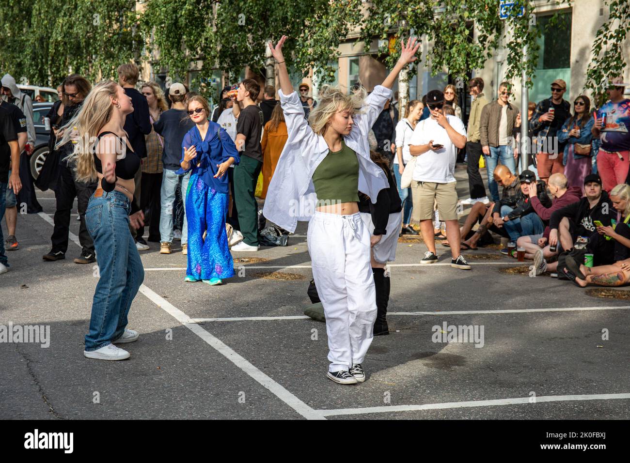 Junge Frauen oder Mädchen, die auf der Kallio Block Party 2022 im finnischen Alpila-Viertel auf der Straße tanzen Stockfoto