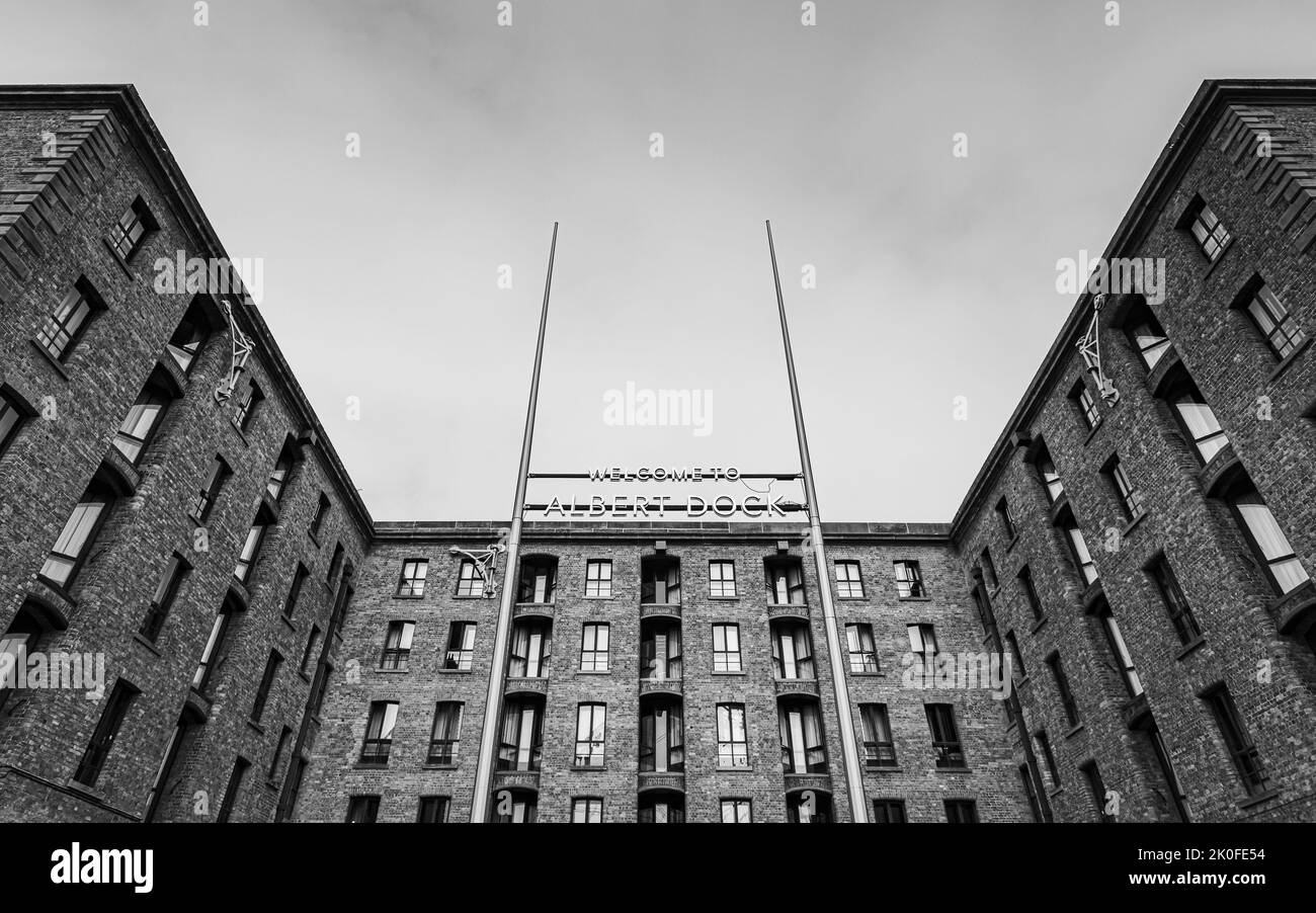 Ein hohes Schild, das den Eingang zum Royal Albert Dock kennzeichnet, das im September 2022 in Liverpool in Schwarz-Weiß abgebildet wurde. Stockfoto