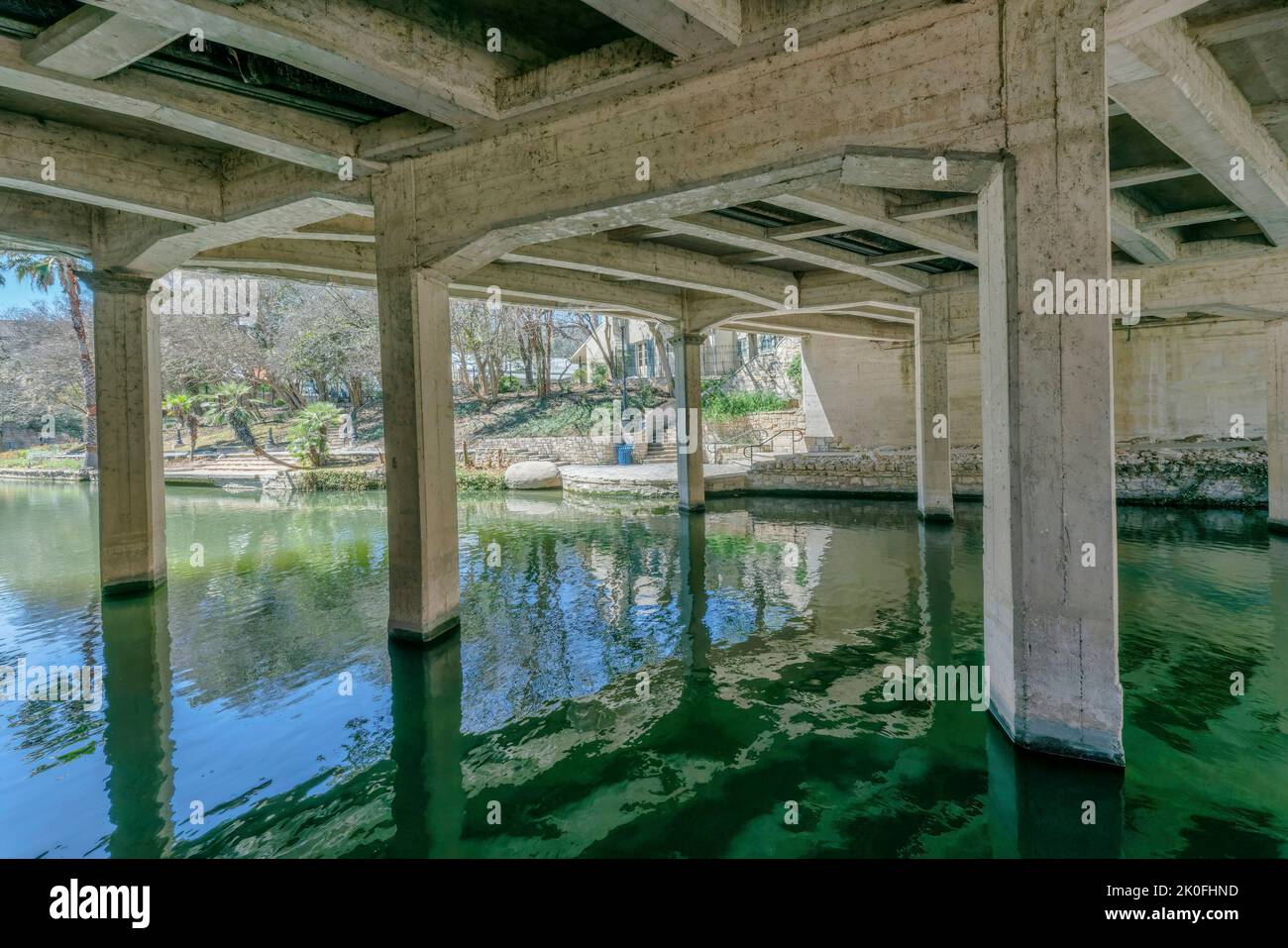 Blick auf den Kanal unter der Brücke am River Walk in San Antonio Texas. Wege und Gebäude für Touristen Sehenswürdigkeiten können in der sonnigen b gesehen werden Stockfoto