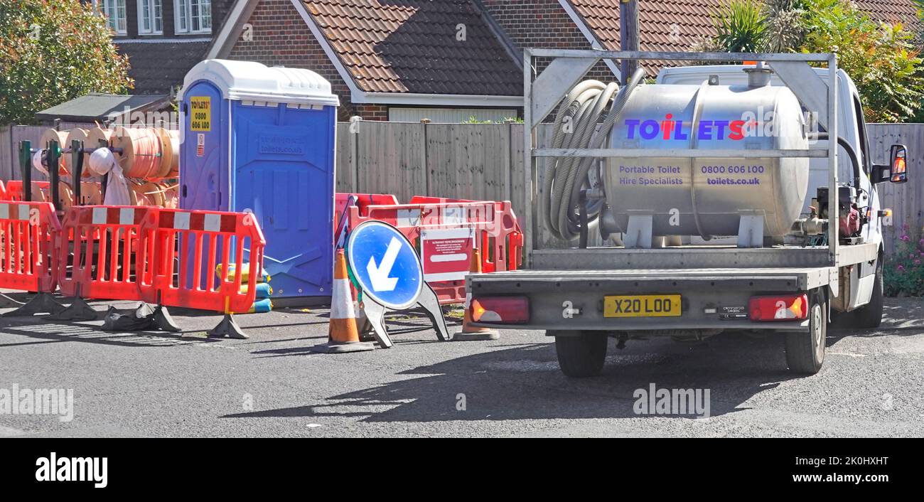 Arbeiter tragbare blaue WC-Toilettenkabine gewartet & Exkremente Entleerung zu Tankwagen LKW durch Pumpenschlauch Straße Baustelle temporäre Verbindung England Großbritannien Stockfoto