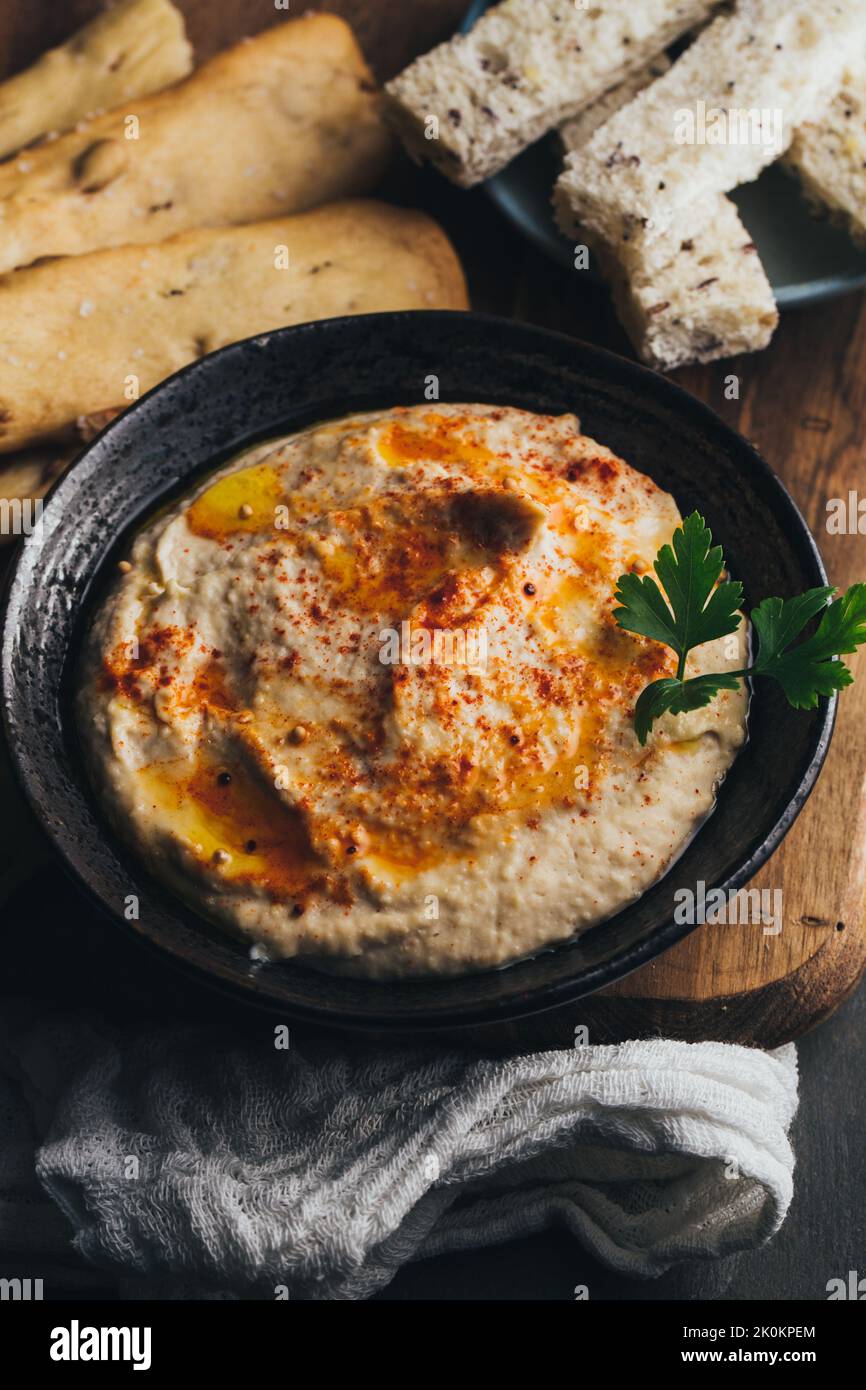 Leckerer Hummus mit Paprika, Olivenöl und etwas Brot zum Eintauchen Stockfoto