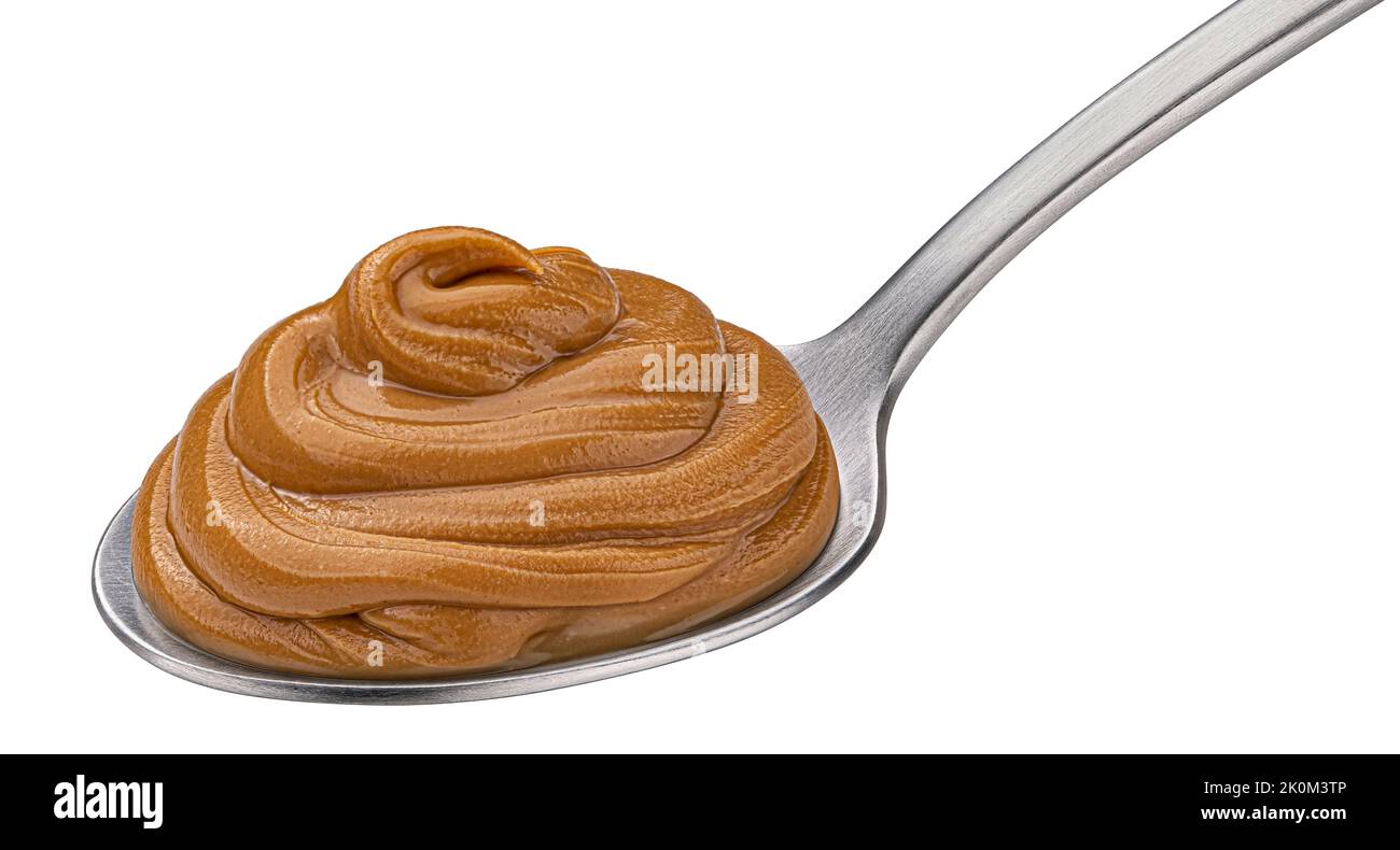 Erdnussbutter in Löffel isoliert auf weißem Hintergrund Stockfoto