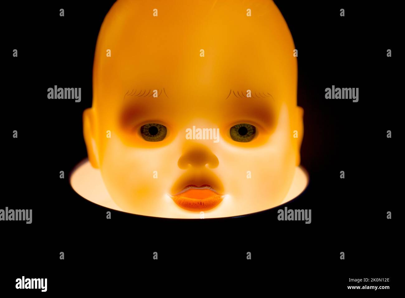 Der Kopf der Kinderpuppe wird von innen beleuchtet. Halloween-Konzept. Stockfoto