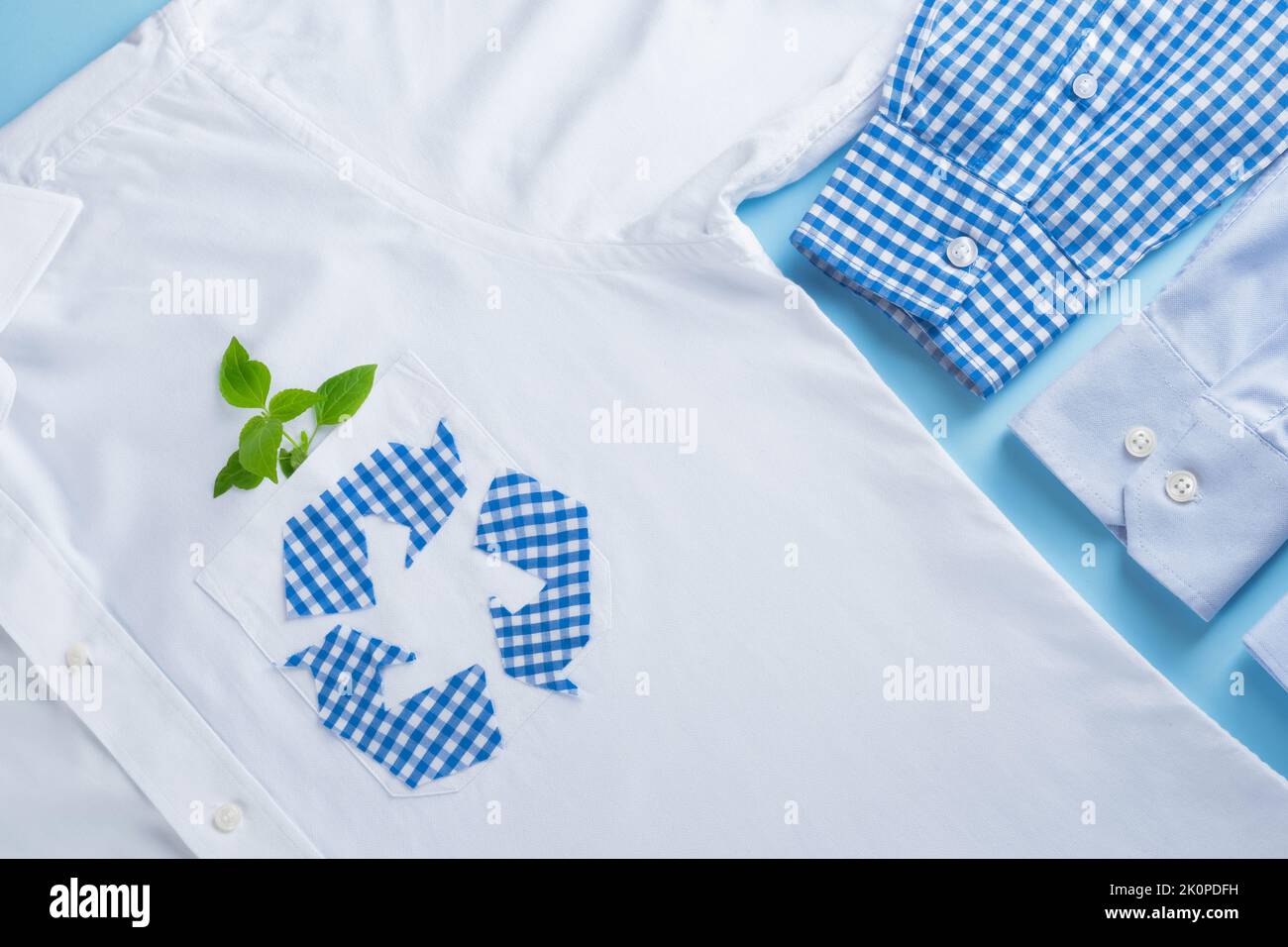 Recycling-Pfeil-Symbol aus einem alten karierten Hemd. Ökologische und nachhaltige Mode. Slow-Fashion-Konzept Stockfoto