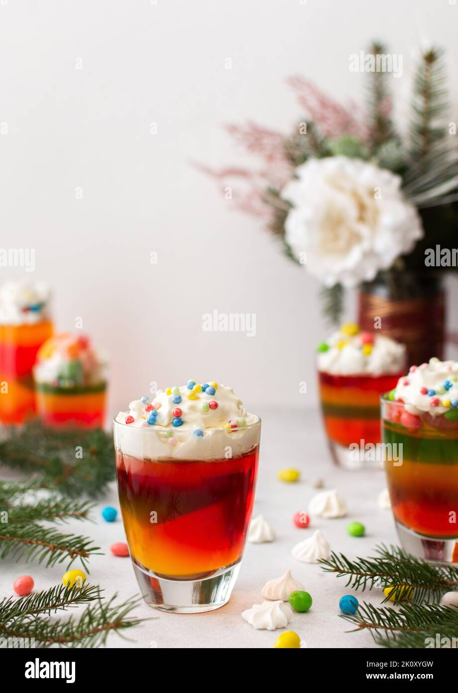Gläser mit buntem Gelee, dekoriert mit Creme und Dragees, Bagues und Marschmalmen, türkischem Delight und Marmelade Stockfoto