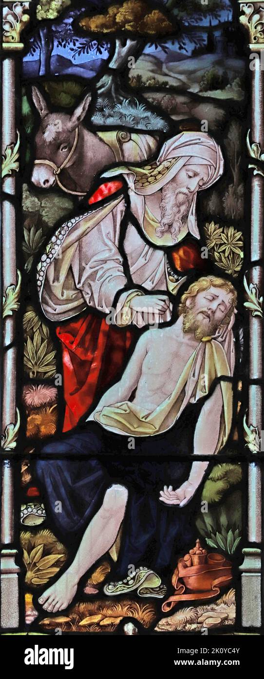 Buntglasfenster von 1901 von Percy Bacon & Brothers, das das Gleichnis vom barmherzigen Samariter darstellt, Kirche St. Wenna, St. Wenn, Cornwall Stockfoto