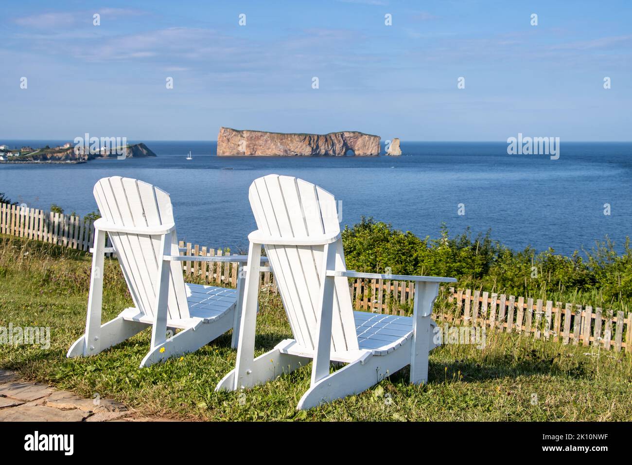 Zwei Adirondack-Stühle und Perce Rock im Hintergrund. Gaspe Peninsula, Quebec, Kanada. Die Stühle waren dort platziert, um diese schöne Aussicht zu beobachten. Stockfoto