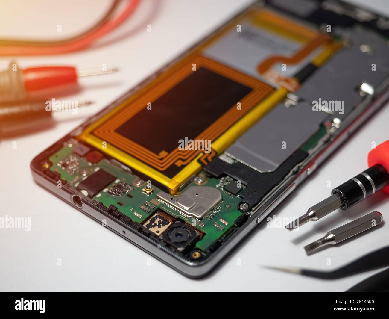 Smartphone-Techniker repariert die Hauptplatine eines Smartphones am Service-Labortisch. Elektronisches Hardware-Upgrade und Reparaturkonzept Stockfoto