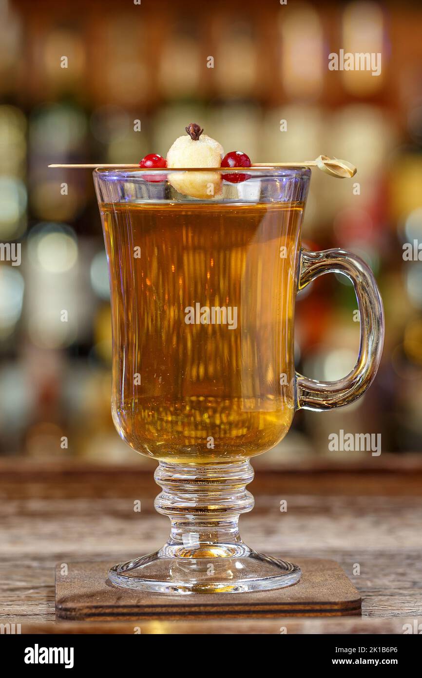 Alkoholfreier Glühwein, garniert mit Apfel, mit Gewürzen im Glas, steht ...