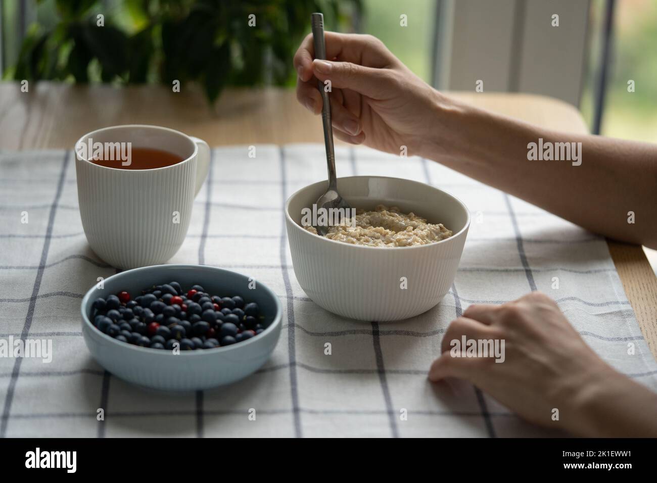 Frau essen gesundes Frühstück mit Haferbrei Haferbrei mit Sommerbeeren. Diät, Gewichtsverlust. Stockfoto