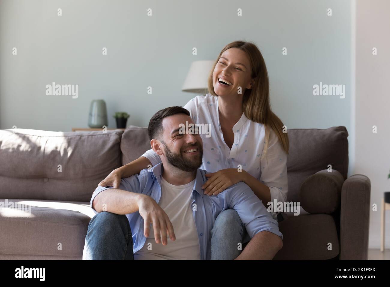 Glückliches attraktives Paar, das Freizeit zu Hause genießt, Stockfoto
