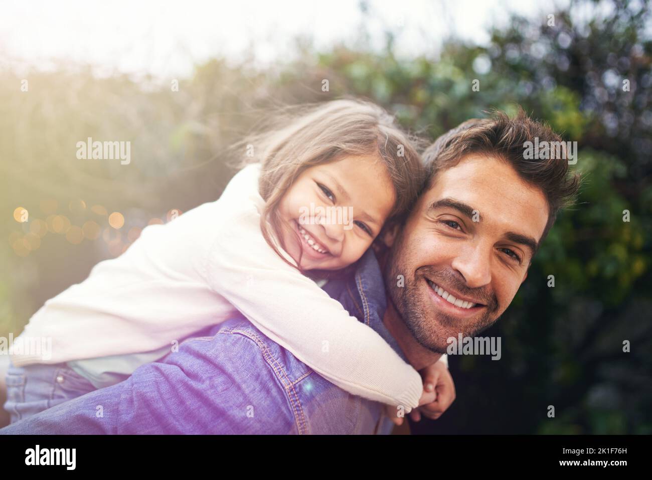 Mein kleines Mädchen ist meine Welt. Ein kleines Mädchen und ihr Vater spielen draußen zusammen. Stockfoto