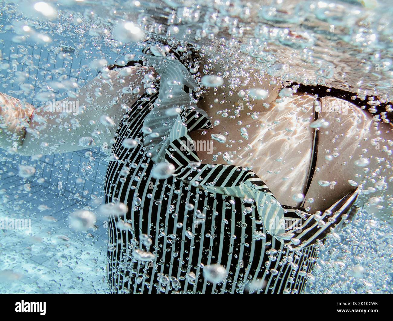 Nahaufnahme eines Mädchens, das unter Wasser in einem Schwimmbad schwimmt Stockfoto