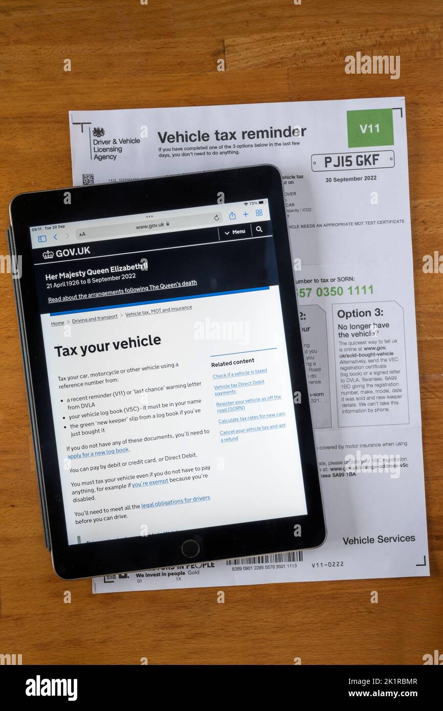 Eine Form V11 Vehicle Tax Reminder Notice von der Driver & Vehicle Licensing Agency. Die DVLA-Website wird auf einem ipad angezeigt. Stockfoto