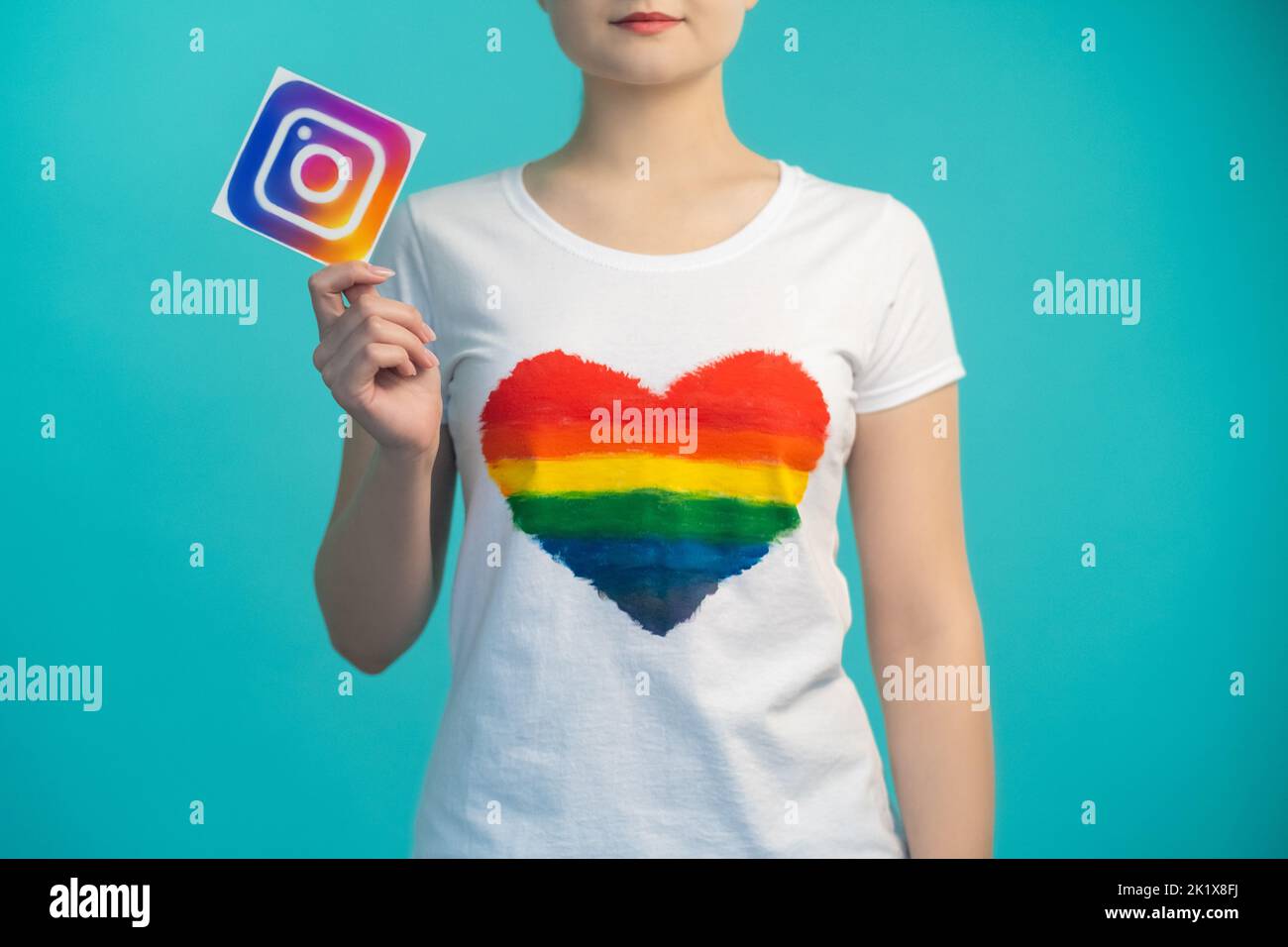 Kharkiv, Ukraine - 27. November 2020: Instagram-Icon. Soziale Medien. Mobile Anwendung. Online-Community. Frau im Herzen wie T-Shirt Hand hält App Stockfoto