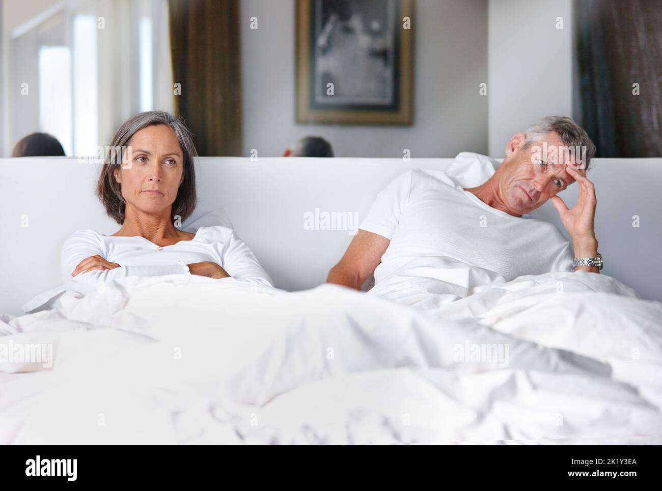 Sie sprechen nicht miteinander ... ein reifes Ehepaar verärgert miteinander im Schlafzimmer. Stockfoto