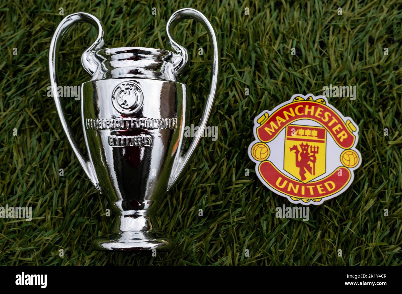 21. April 2021, Moskau, Russland. Das Emblem des Fußballvereins Manchester United F.C. und des UEFA Champions League Cups auf dem grünen Rasen des sta Stockfoto