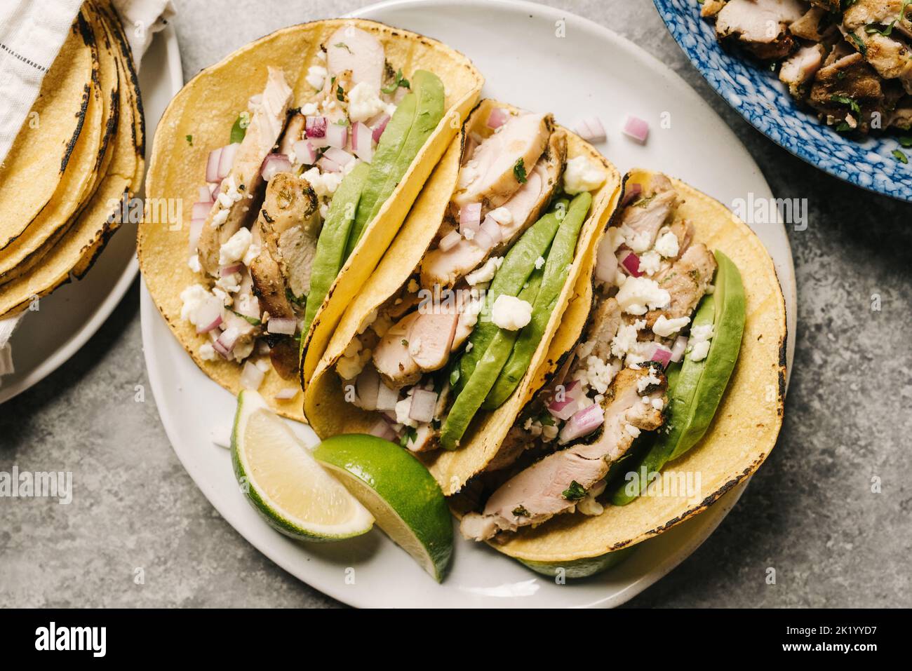 Koriander-Tacos mit Lime Chicken mit Avocado und roter Zwiebel Stockfoto