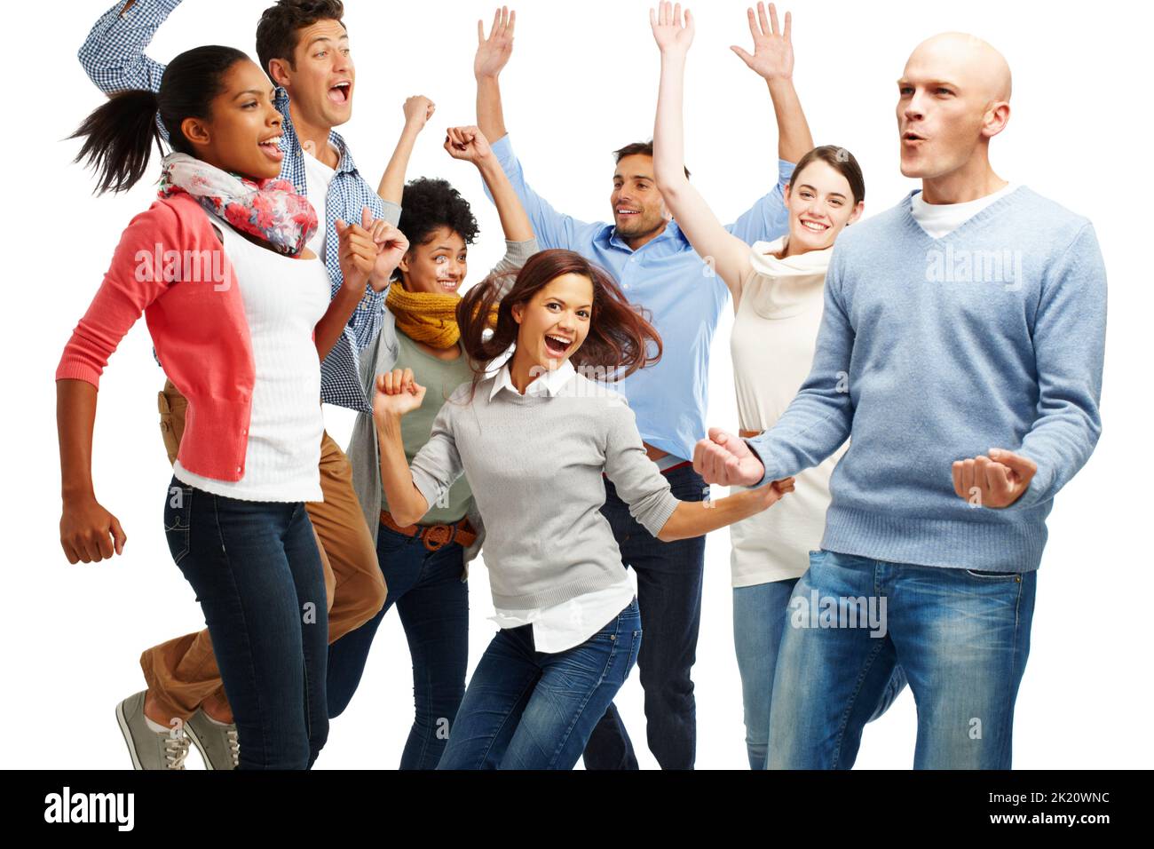 Ja. Gruppe von lässig gekleideten jungen Erwachsenen, die aufgeregt vor weißem Hintergrund springen. Stockfoto