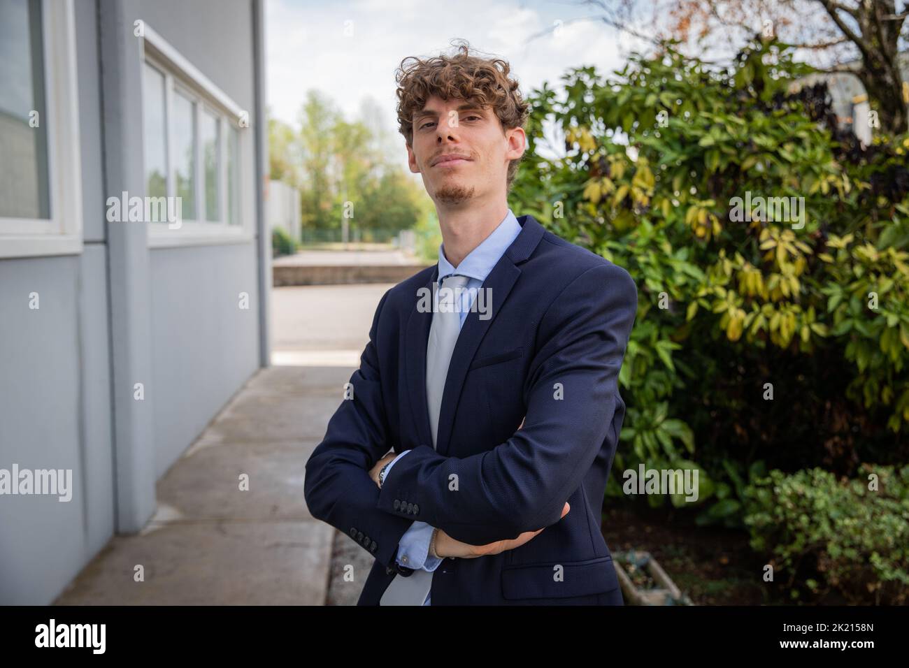 Geschäftsmann mit gefalteten Armen, kaukasischer Mann elegant im Freien gekleidet. Stockfoto