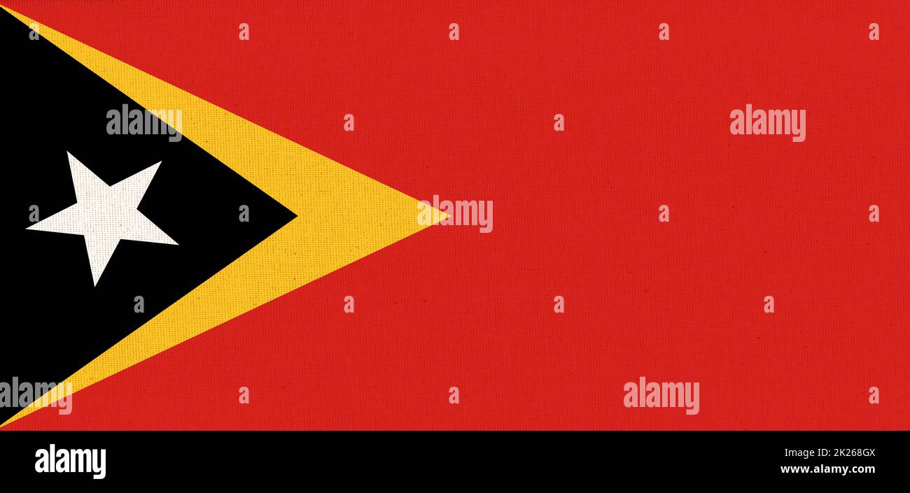 Flagge Osttimors. Osttimorflag auf Stoffoberfläche. Stoffstruktur Stockfoto