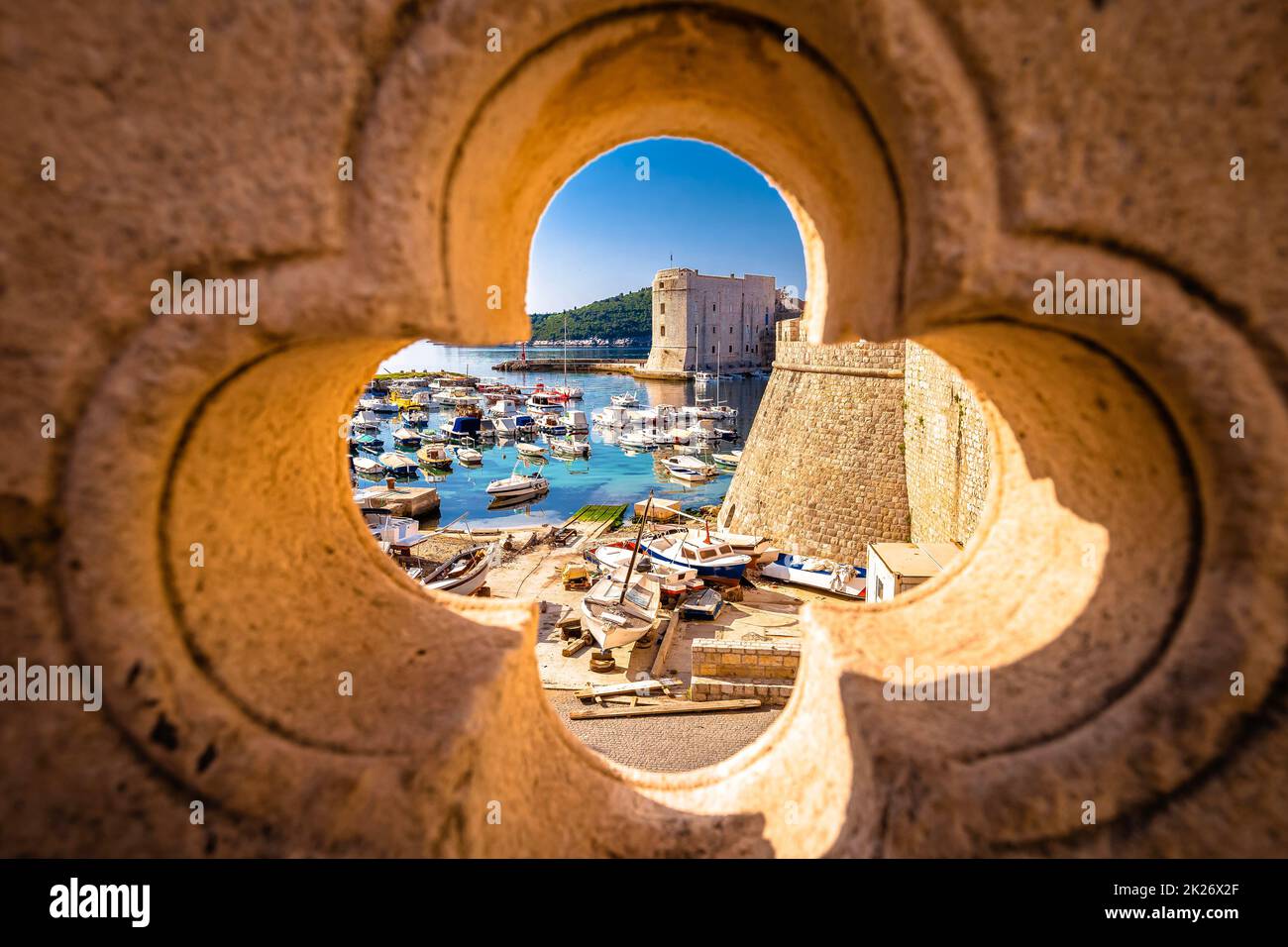 Dubrovnik. Blick auf den historischen Hafen von Dubrovnik durch eine Steinmauer Stockfoto
