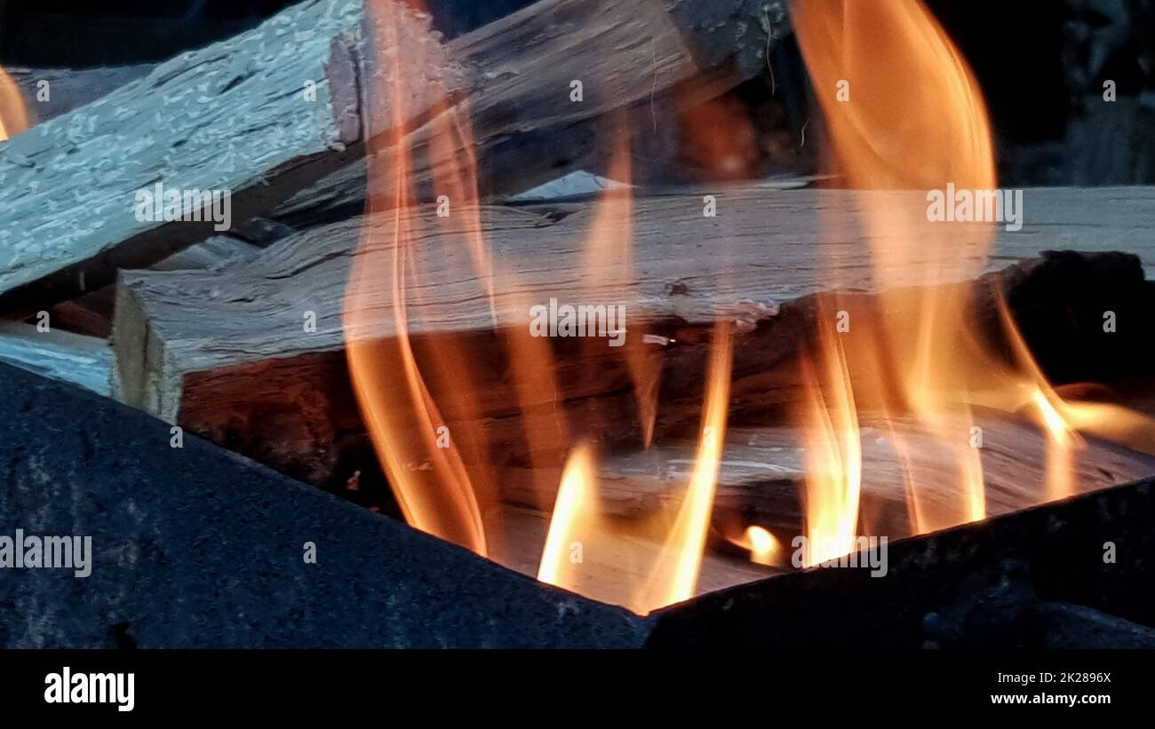 Flammentanz, Barbecue am offenen Feuer. Feuer im Grill mit brennendem Holz. Bereiten Sie Holzkohle vor, bevor Sie Fleisch oder Fisch im Freien grillen. Flamme im Kamin. Grillvorbereitung Stockfoto