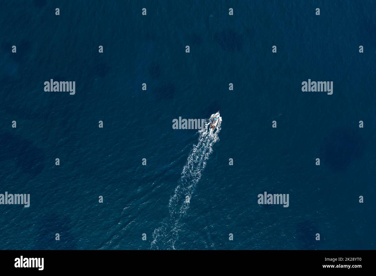 Kleines Fischerboot im tiefblauen Meer. Ansicht von oben Stockfoto