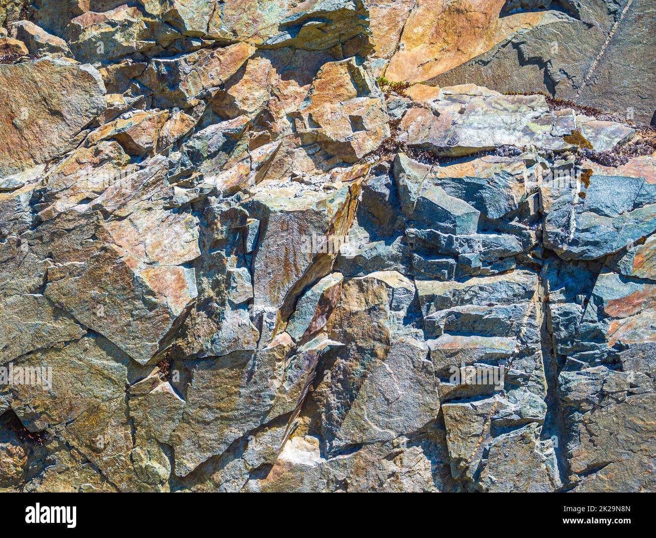 Steinstruktur mit orangefarbenem Moos und Flechten Norwegen. Stockfoto
