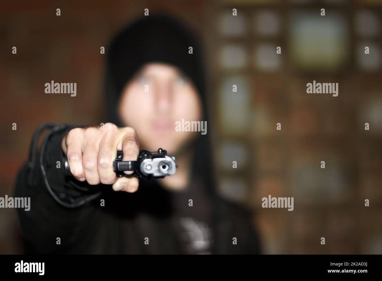 Kriminell unter Kontrolle. Blick auf einen Mann, der eine Waffe in der Hand hält und auf Sie zeigt. Stockfoto