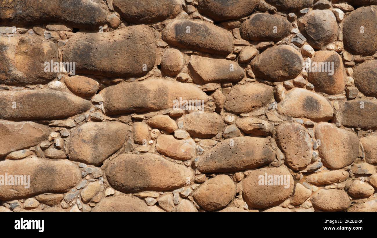Textur einer Steinwand. Alte Burg Steinwand Hintergrund. Steinwand als Hintergrund oder Textur. Teil einer Steinwand, für Hintergrund oder Textur Stockfoto