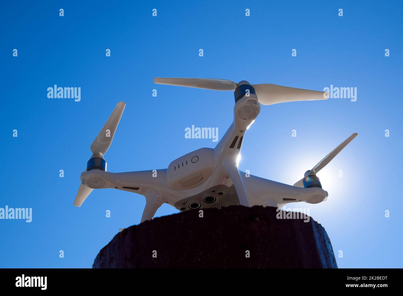 Quadrocopter Phantom 4 gegen den blauen Himmel in der Sonne. Hintergrundbeleuchtung. Dron ist ein innovatives fliegenden Roboter. Stockfoto
